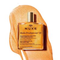 a  dry  oil  with  gold  pigments  indicated  for  illuminating  face