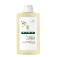 Bottle  of  Klorane  Almond  Milk  Shampoo  by  Klorane,  a  fluid  shampoo  indicated  for  moisturizing  and  soothing  all  hair  types.