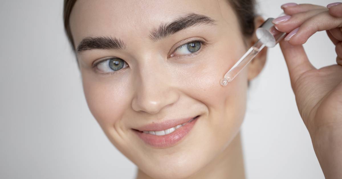 Woman applying facial serum