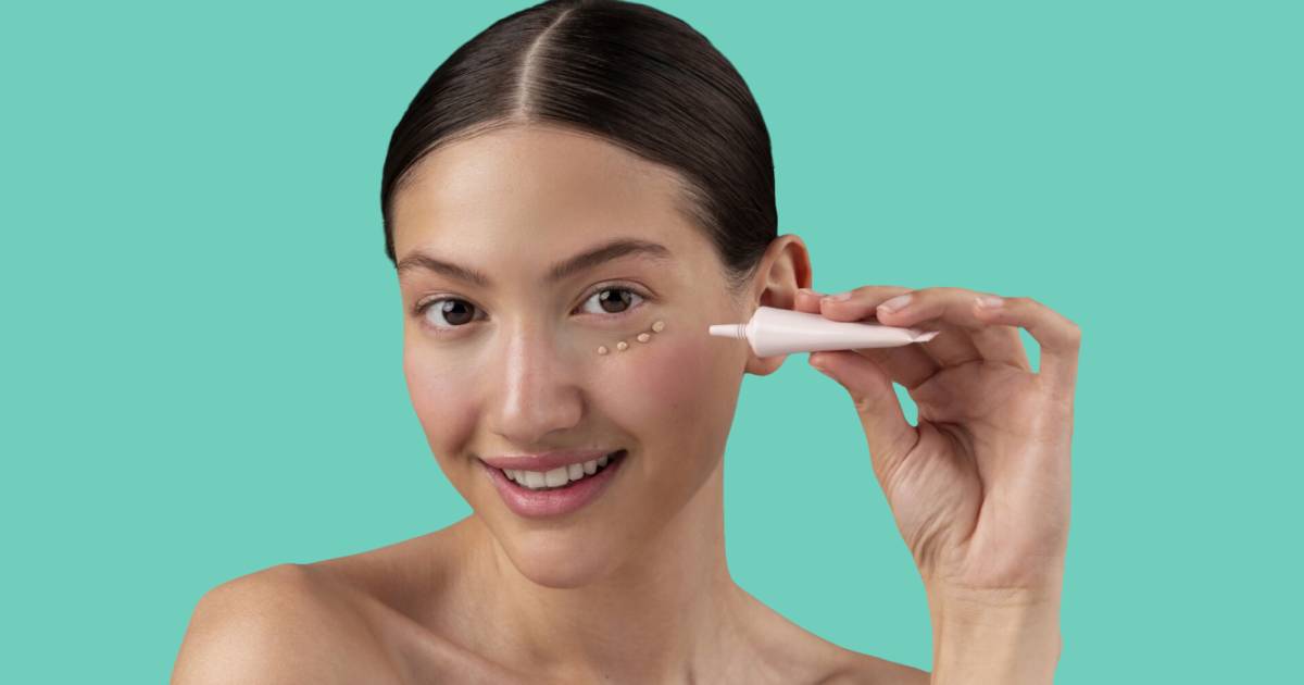 Woman applying eye cream