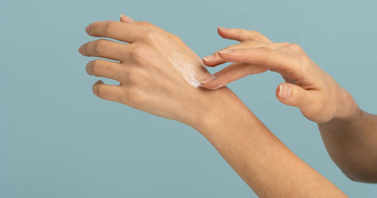 Woman applying hand cream