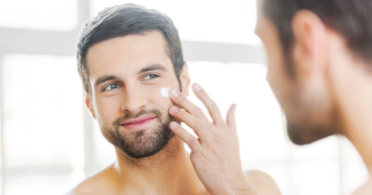 man applying skincare products