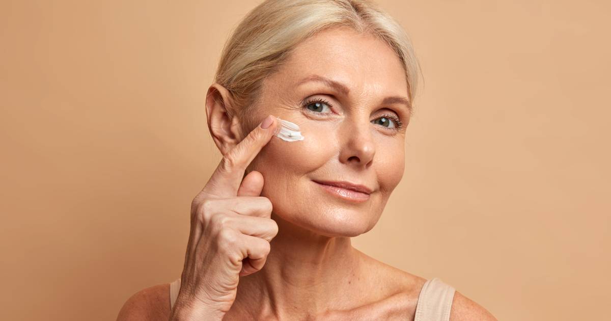 Woman applying retinoid serum