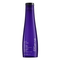 Bottle  of  Shu  Uemura  Yubi  Blonde  Glow  Revealing  Shampoo,  a  nourishing  shampoo  indicated  for  blonde  hair  radiance.