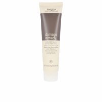 Bottle  of  Aveda  Damage  Remedy  Daily  Hair  Repair  by  Aveda,  a  leave-in  treatment  indicated  for  detangling  and  repairing  damaged  hair.