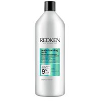 Bottle  of  Redken  Acidic  Bonding  Curls  Shampoo  by  Redken,  a  fortifying  shampoo  indicated  for  processed  curly  and  coily  hair.