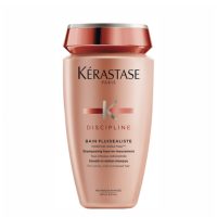Bottle  of  Kérastase  Discipline  Bain  Fluidéaliste  Shampoo  by  Kérastase,  a  shampoo  indicated  for  controlling  frizz  in  unruly  hair.