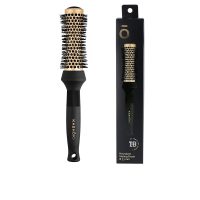 Product  container  of  Kashōki  Hourglass  Brush  33mm  by  Kashōki,  a  styling  brush  indicated  for  shaping  hair  when  blow  drying.