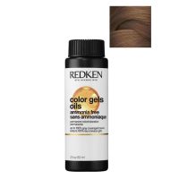 Product  container  of  Redken  Color  Gel  Oils  by  Redken,  a  liquid  color  indicated  for  grey  coverage  and  hair  shine.